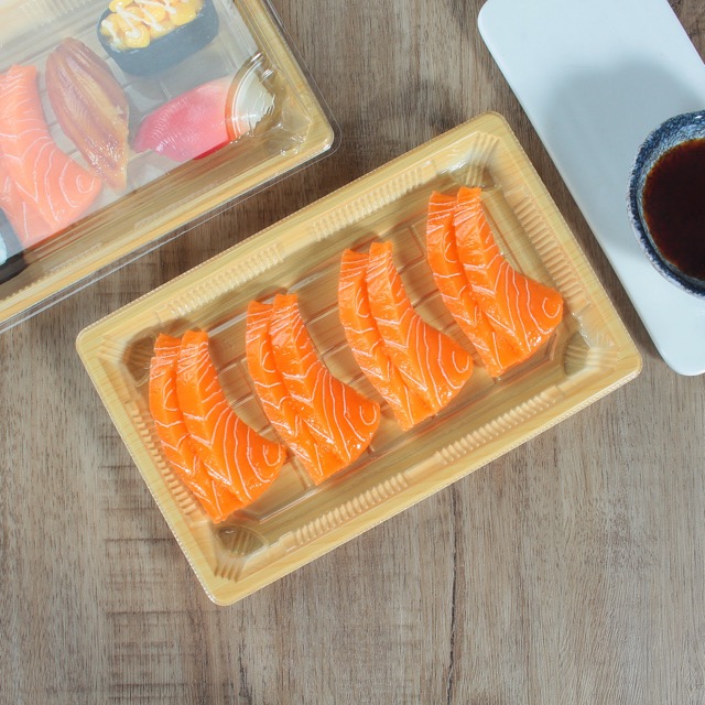 wl-09 wooden plastic sushi container with four piece of sushi in it