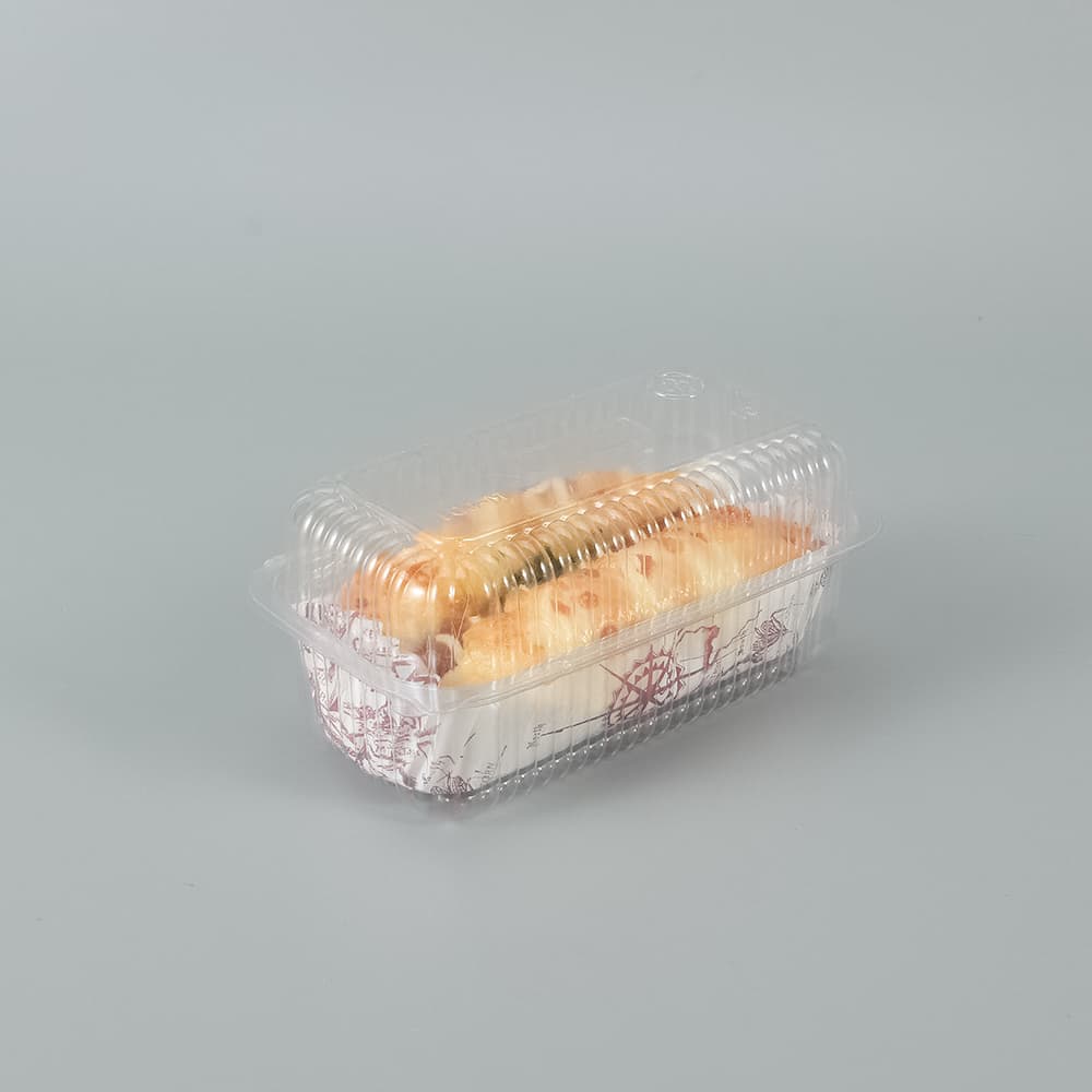 A combined clear clamshell container contains a hot dog bun