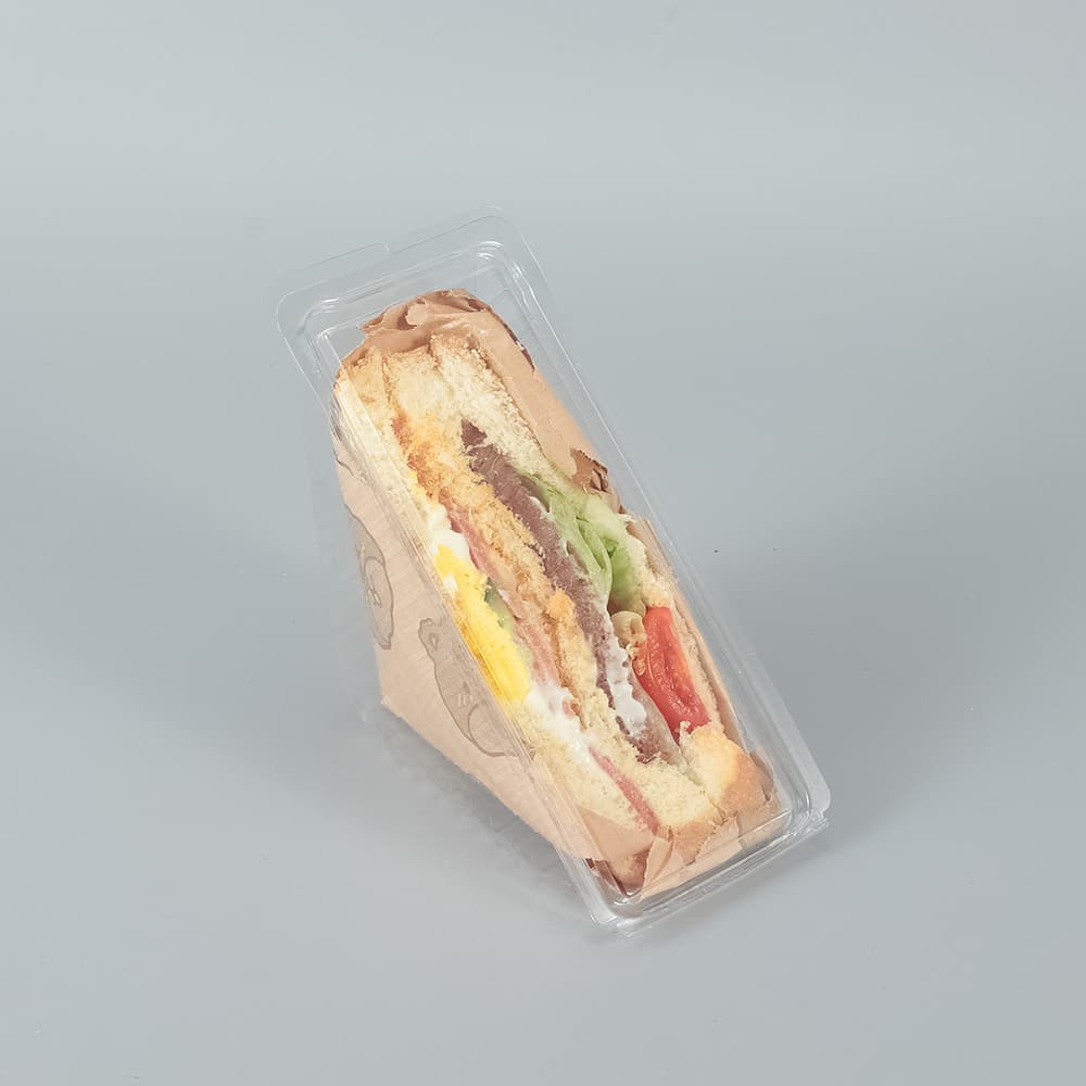 A clear clamshell container filled with sandwiches