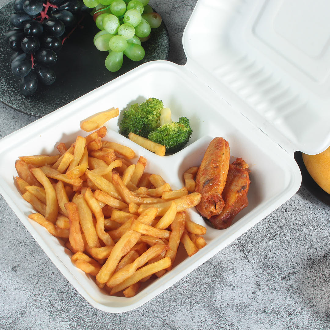sugarcane bagasse 3 compartment clamshell container with chips,chicken wings and vegetable in it
