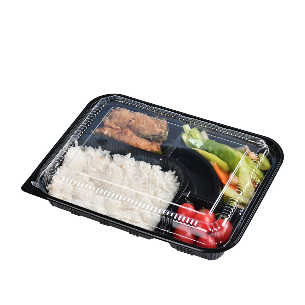 A black 5-compartment bento box with a closed lid and each containing vegetables, fruits, meat slices and rice
