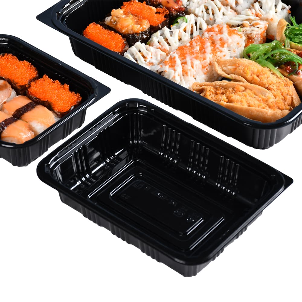 One black bento box without food and two bento boxes containing sushi with only the corners exposed