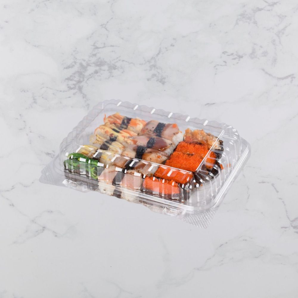 A transparent clamshell container with different sushi food placed on a light gray background