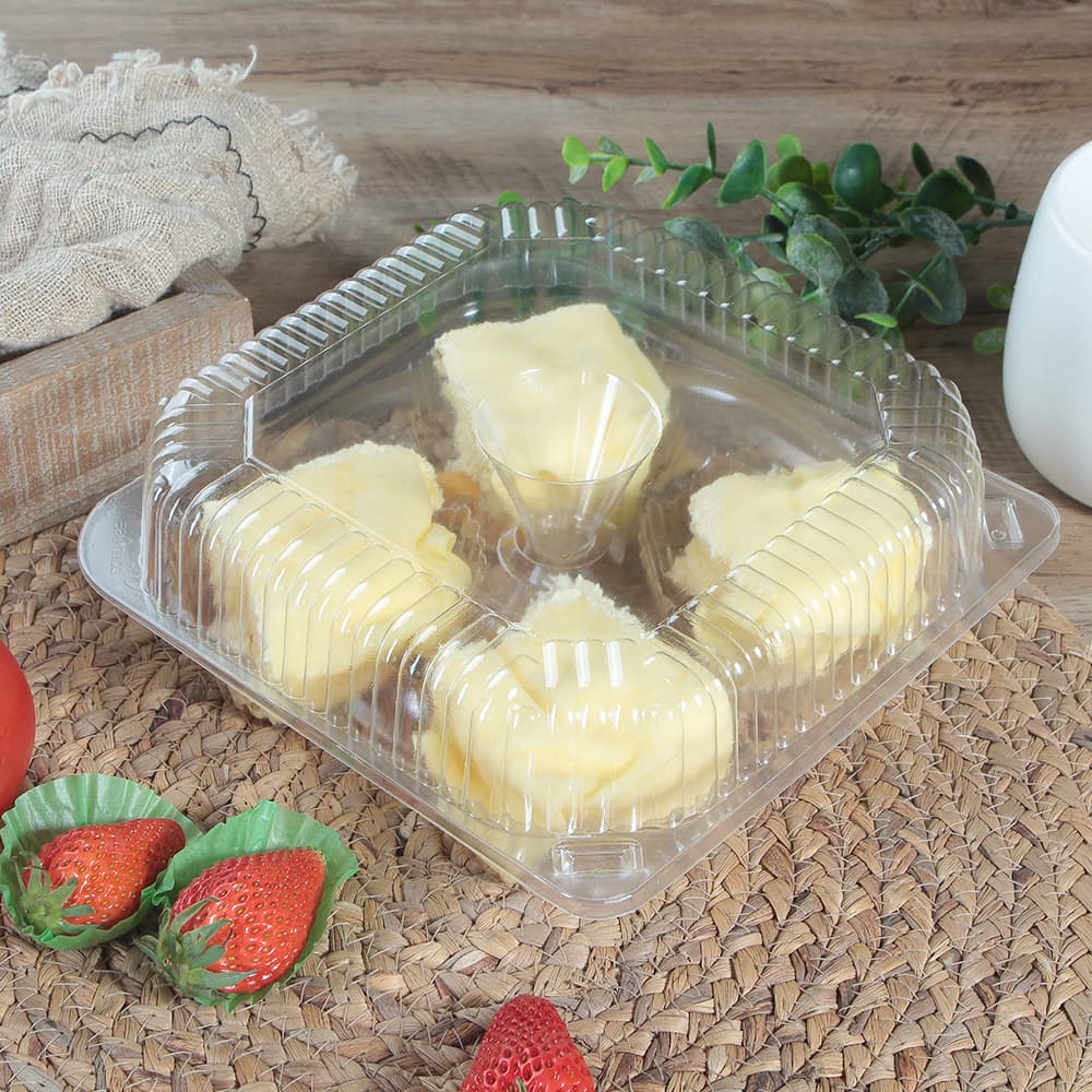 4 yellow cream cupcakes inside a closed clear flip cupcake container