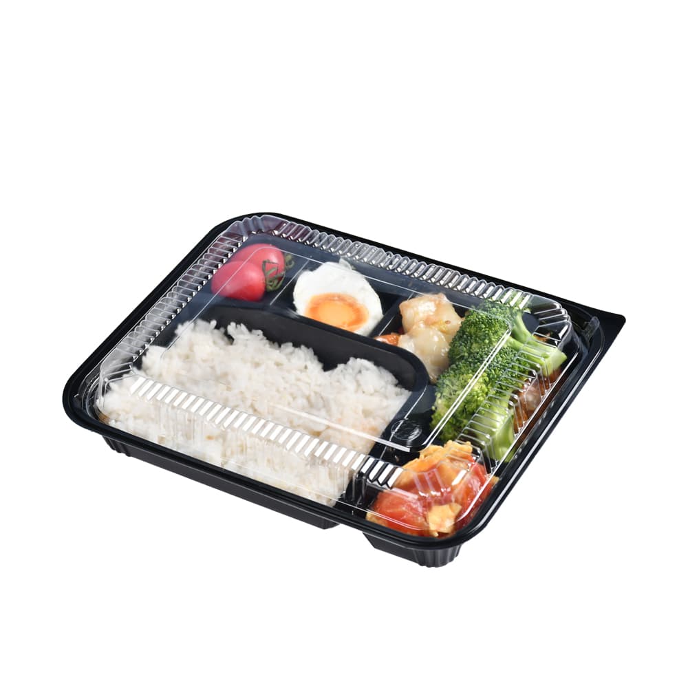A black 5-compartment bento box with a lid and filled with vegetables, fruits, eggs and rice
