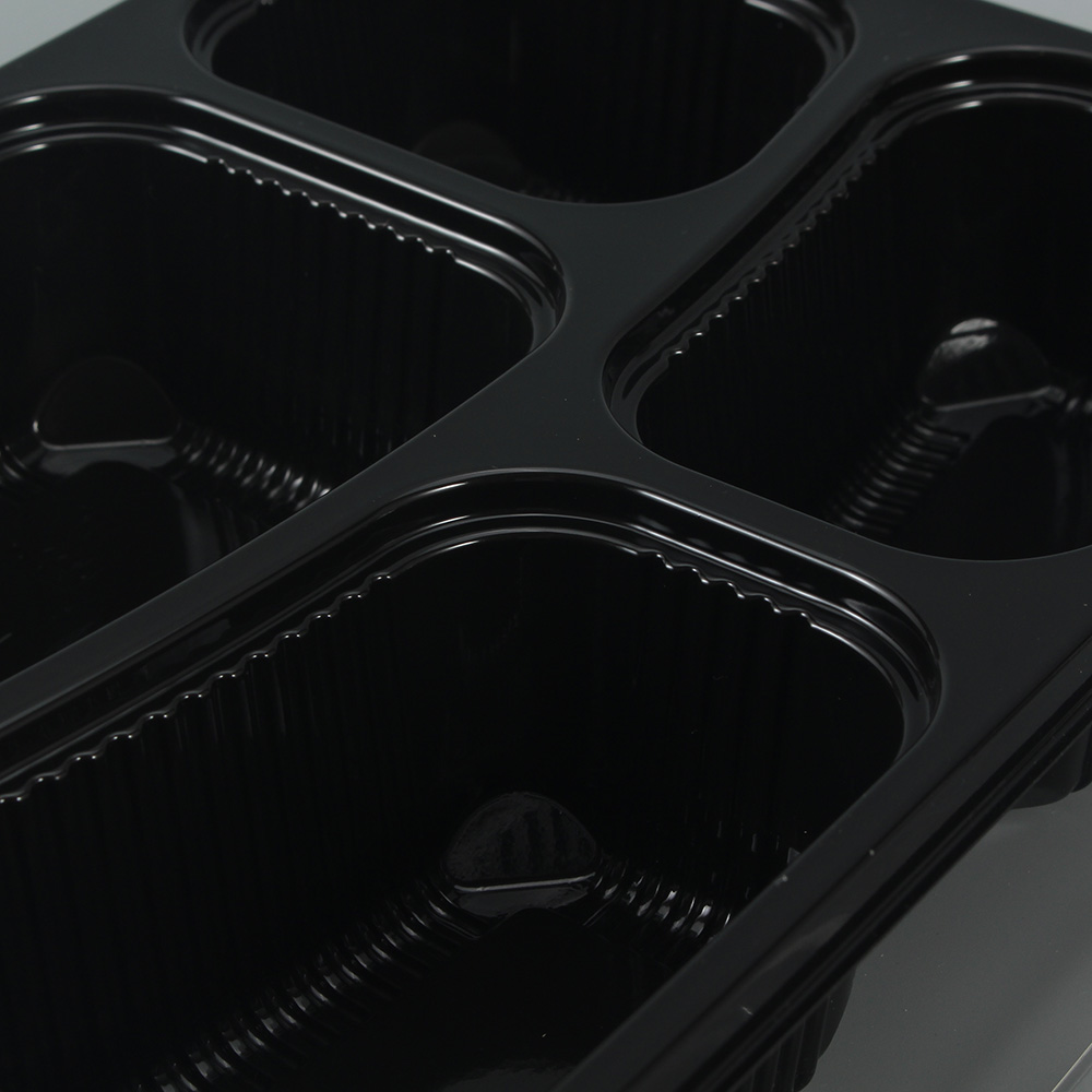 Detailed display of the compartments of a black 4-compartment bento box