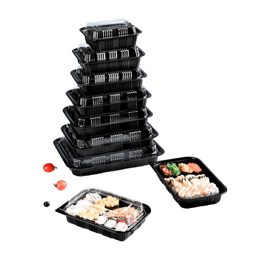 Lunch boxes of different sizes are stacked together and there are also two lunch boxes with food on the table