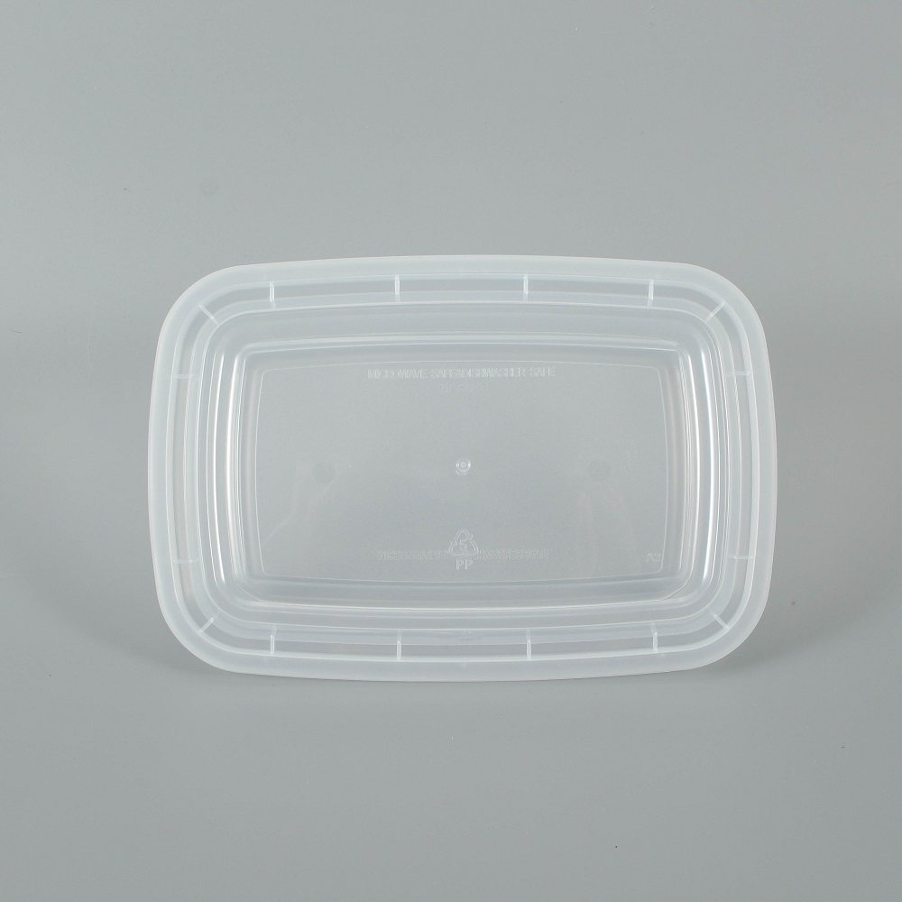 A transparent disposable plastic bento box is placed on a gray background